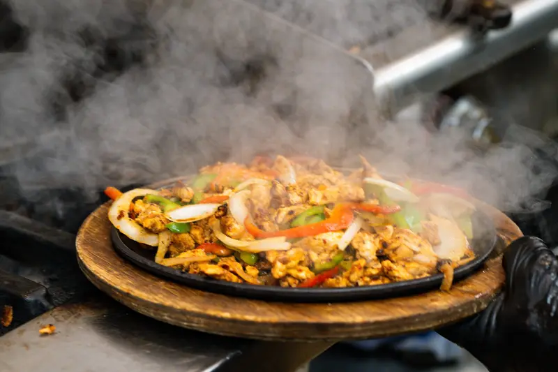 Sizzling fajitas with steam at Viva Leawood