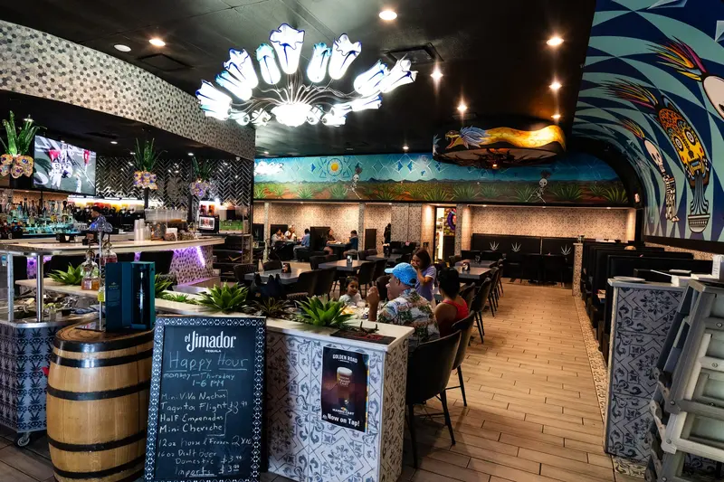 Dining room and bar under the skull chandelier at Viva Leawood