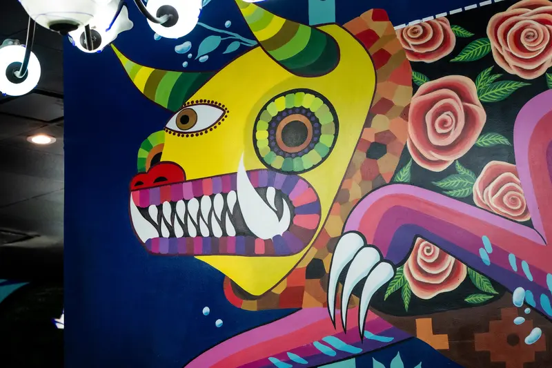 Mural of a calavera with roses at Viva Leawood