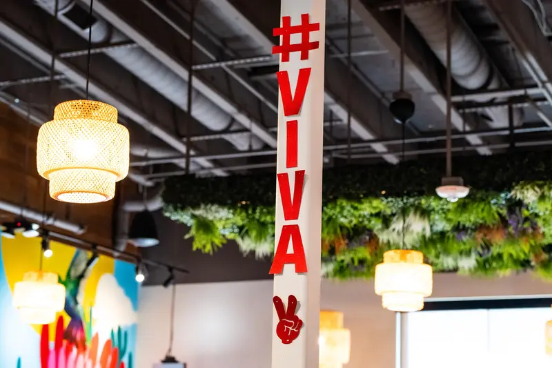 The #VIVA banner under pendant lights at Viva Olathe