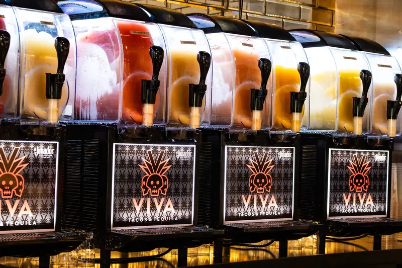 Frozen margarita machines with VIVA skull panels at Viva Olathe