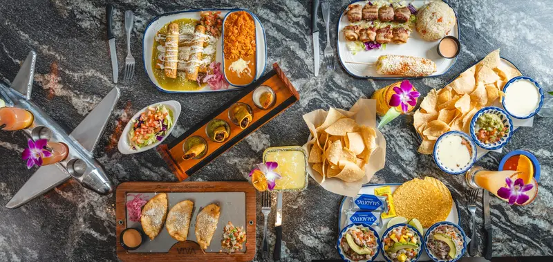 An overhead spread of dishes and drinks at Viva Wichita