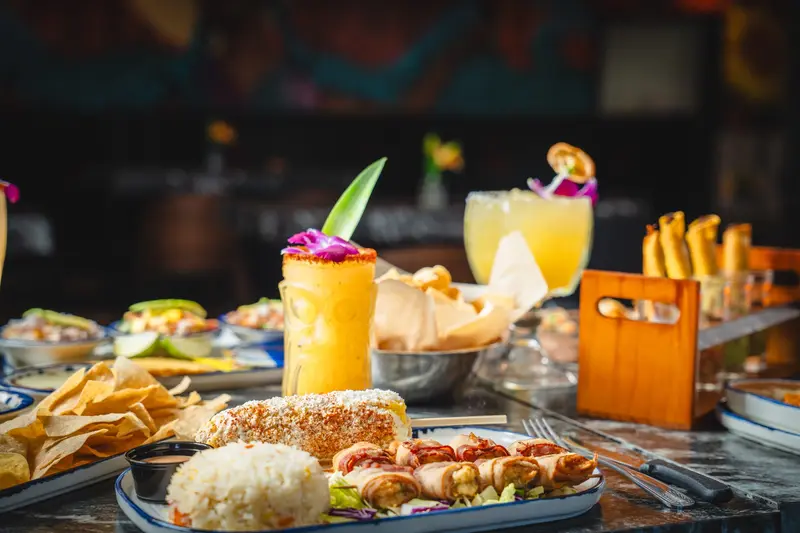 A table spread with cocktails, El Patron and a taco flight at Viva Wichita