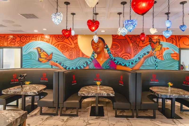 Booths under the long mural at Viva Wichita