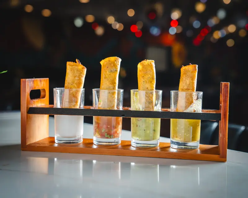 Taco flight: four flour tortilla cones in a wooden rack